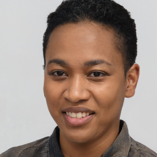 Joyful black young-adult female with short  black hair and brown eyes