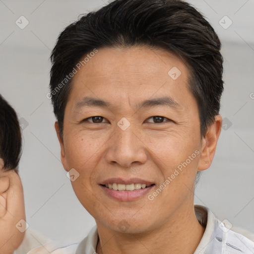 Joyful white adult male with short  brown hair and brown eyes