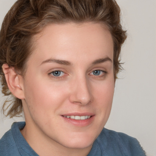 Joyful white young-adult female with short  brown hair and blue eyes