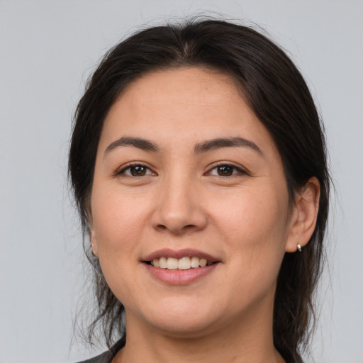 Joyful white young-adult female with medium  brown hair and brown eyes