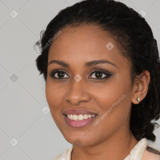 Joyful black young-adult female with medium  black hair and brown eyes