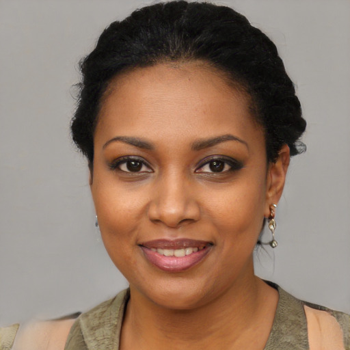 Joyful black young-adult female with short  black hair and brown eyes