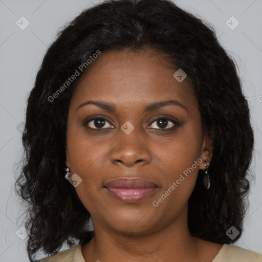 Joyful black young-adult female with long  brown hair and brown eyes