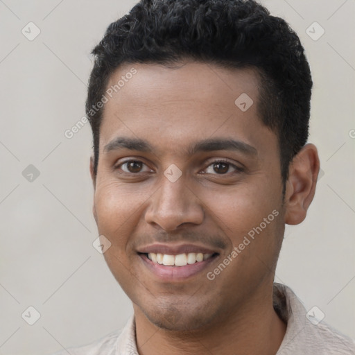 Joyful black young-adult male with short  black hair and brown eyes