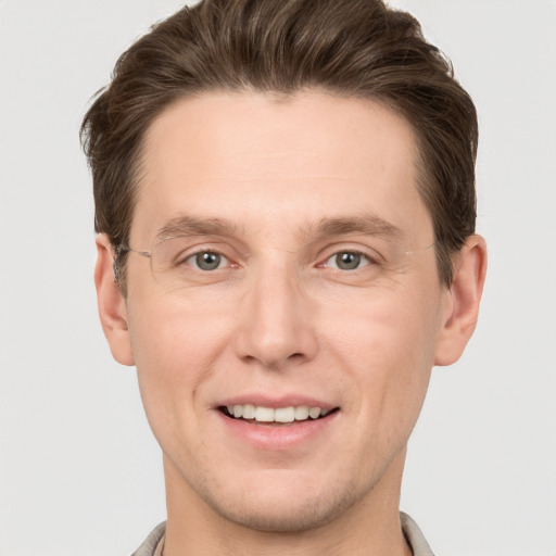 Joyful white adult male with short  brown hair and grey eyes