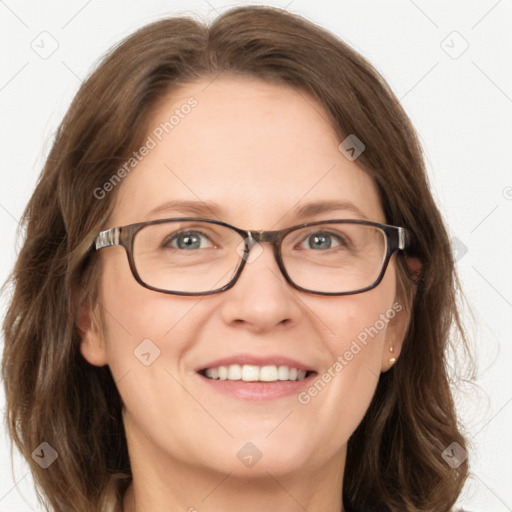 Joyful white adult female with long  brown hair and blue eyes