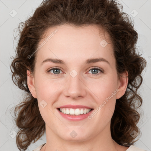 Joyful white young-adult female with medium  brown hair and green eyes