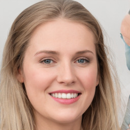 Joyful white young-adult female with long  brown hair and blue eyes