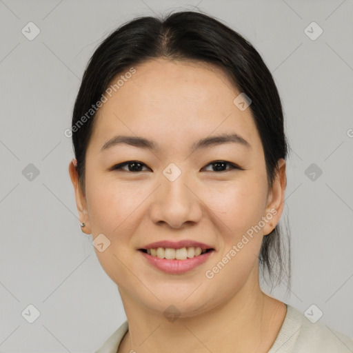 Joyful asian young-adult female with medium  brown hair and brown eyes