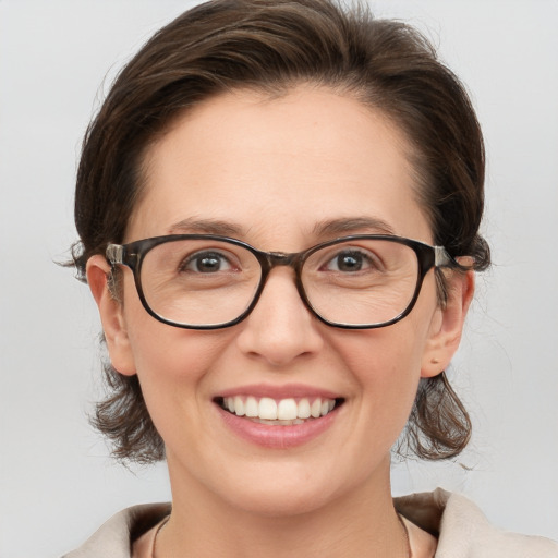 Joyful white young-adult female with medium  brown hair and grey eyes