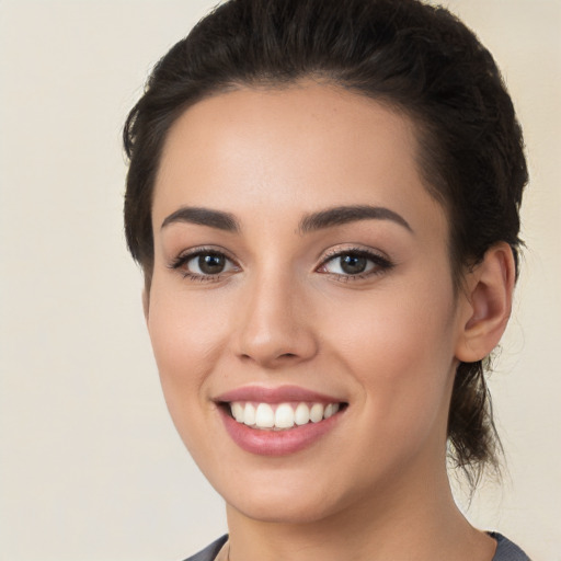 Joyful white young-adult female with short  brown hair and brown eyes