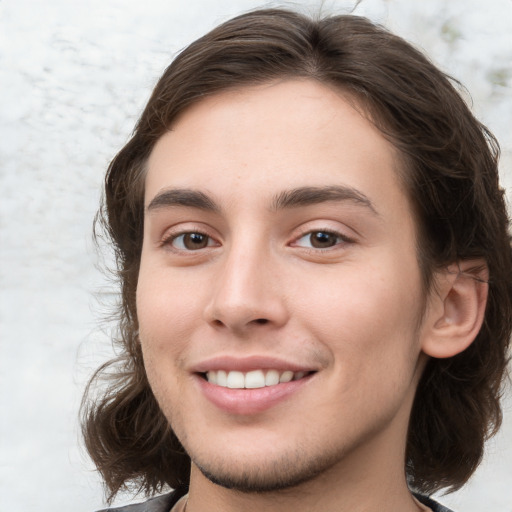 Joyful white young-adult male with medium  brown hair and brown eyes