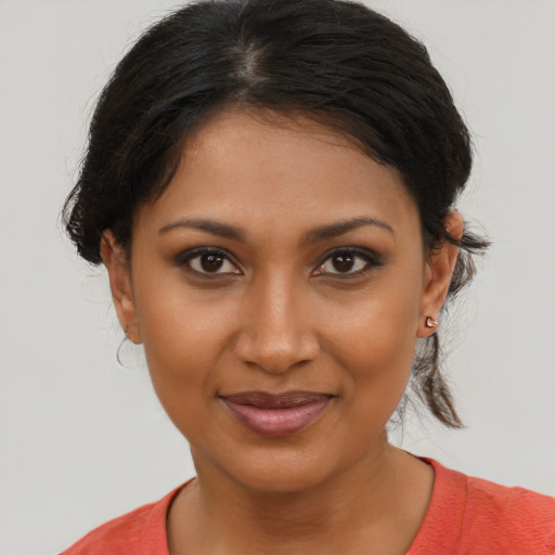 Joyful black young-adult female with medium  brown hair and brown eyes