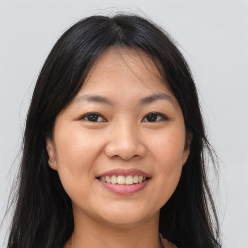 Joyful asian young-adult female with long  brown hair and brown eyes