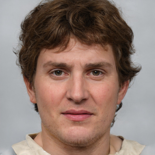 Joyful white adult male with short  brown hair and grey eyes