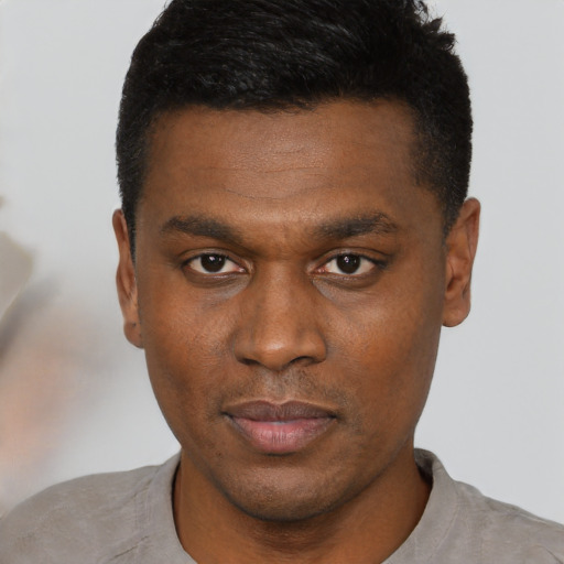 Neutral black young-adult male with short  black hair and brown eyes