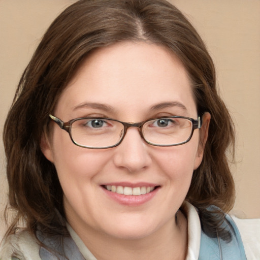 Joyful white adult female with medium  brown hair and blue eyes