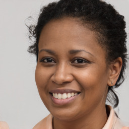 Joyful black young-adult female with long  brown hair and brown eyes