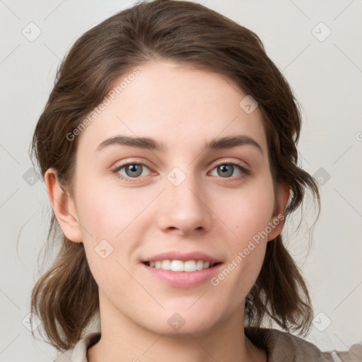 Joyful white young-adult female with medium  brown hair and grey eyes