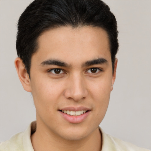 Joyful latino young-adult male with short  brown hair and brown eyes