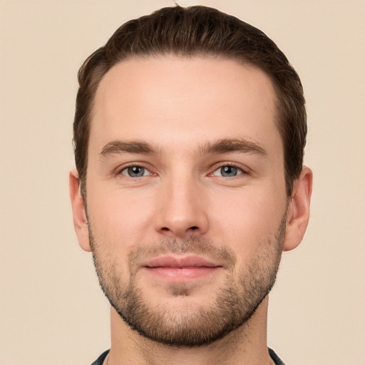 Joyful white young-adult male with short  brown hair and grey eyes