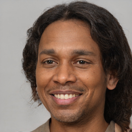Joyful white adult male with medium  brown hair and brown eyes