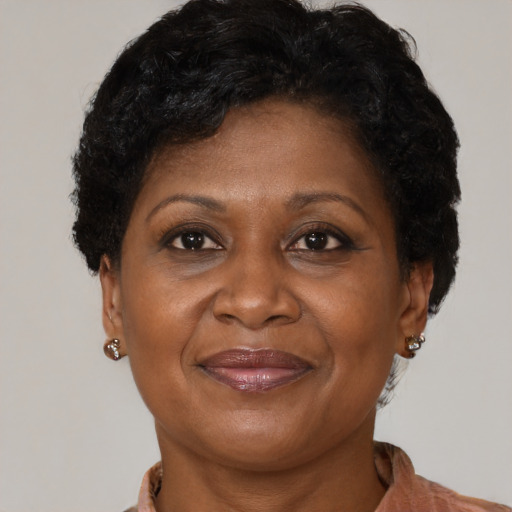 Joyful black adult female with short  brown hair and brown eyes