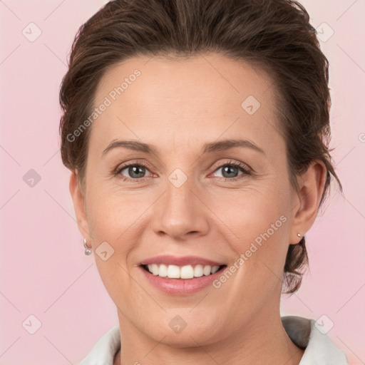 Joyful white adult female with medium  brown hair and grey eyes