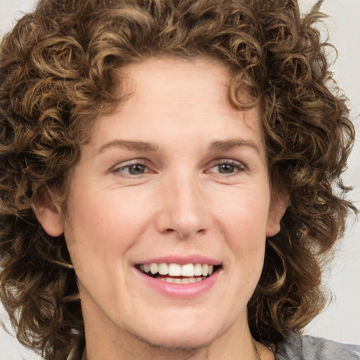 Joyful white young-adult female with medium  brown hair and green eyes