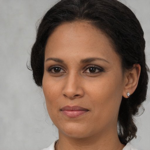 Joyful black young-adult female with medium  brown hair and brown eyes