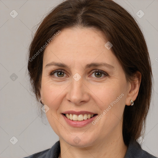 Joyful white adult female with medium  brown hair and grey eyes