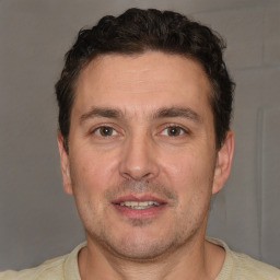 Joyful white adult male with short  brown hair and brown eyes