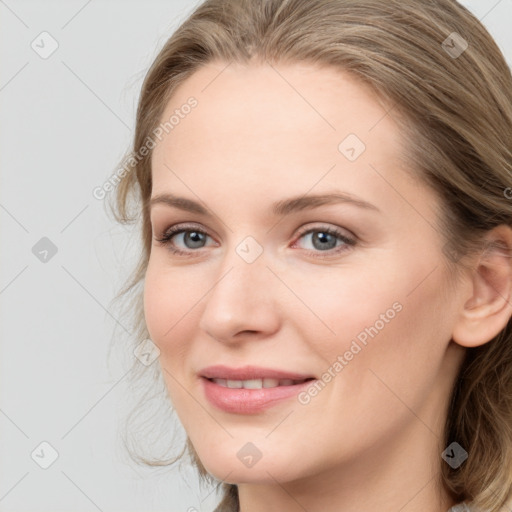 Joyful white young-adult female with medium  brown hair and blue eyes