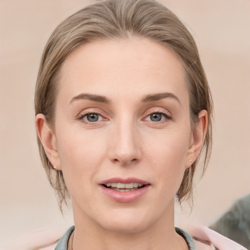 Joyful white young-adult female with medium  brown hair and blue eyes