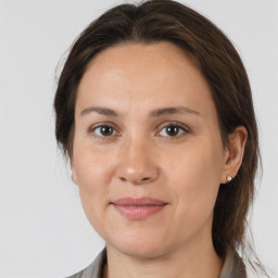 Joyful white adult female with medium  brown hair and brown eyes