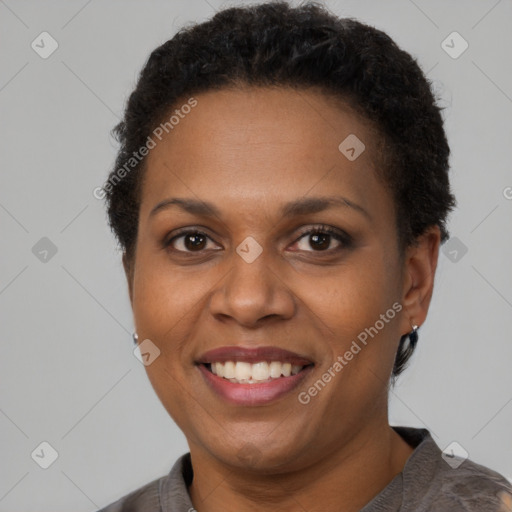 Joyful latino adult female with short  brown hair and brown eyes