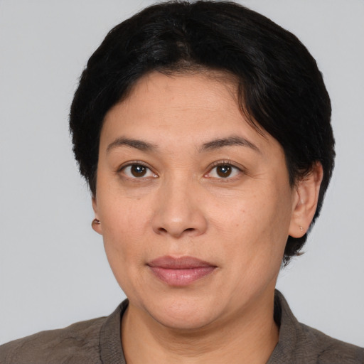 Joyful white adult female with short  black hair and brown eyes