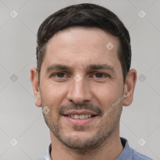 Joyful white young-adult male with short  black hair and brown eyes