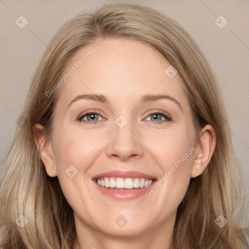 Joyful white adult female with long  brown hair and grey eyes