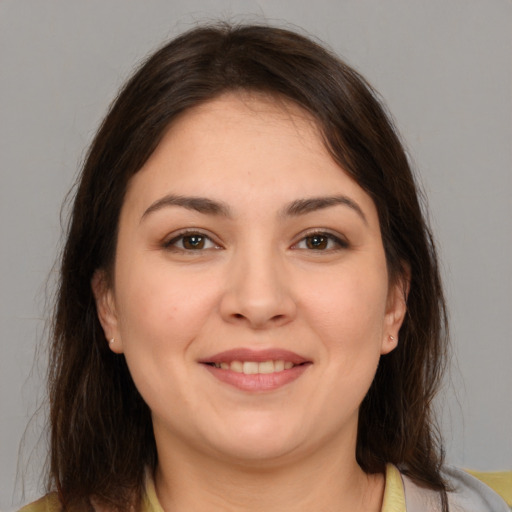 Joyful white young-adult female with medium  brown hair and brown eyes