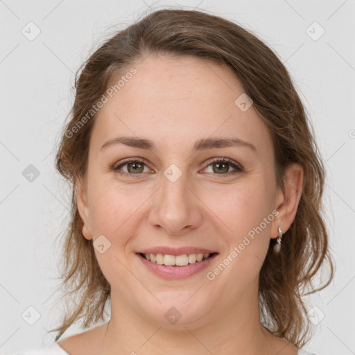 Joyful white young-adult female with medium  brown hair and green eyes