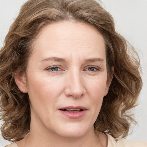 Joyful white young-adult female with medium  brown hair and blue eyes