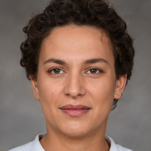 Joyful white adult female with short  brown hair and brown eyes
