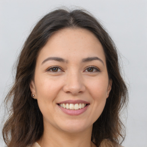 Joyful white young-adult female with long  brown hair and brown eyes