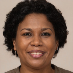 Joyful black adult female with short  brown hair and brown eyes