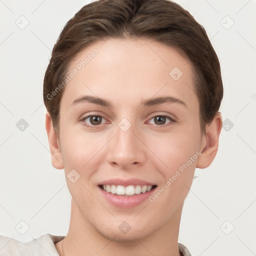 Joyful white young-adult female with short  brown hair and brown eyes