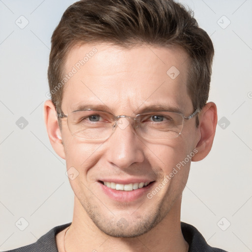 Joyful white adult male with short  brown hair and grey eyes