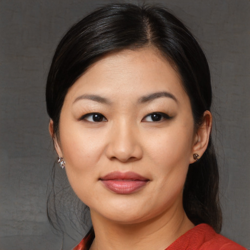Joyful asian young-adult female with medium  black hair and brown eyes