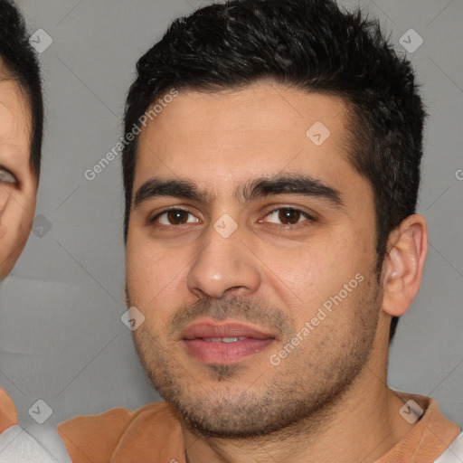 Joyful white young-adult male with short  black hair and brown eyes