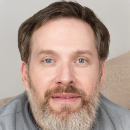 Joyful white adult male with short  brown hair and grey eyes